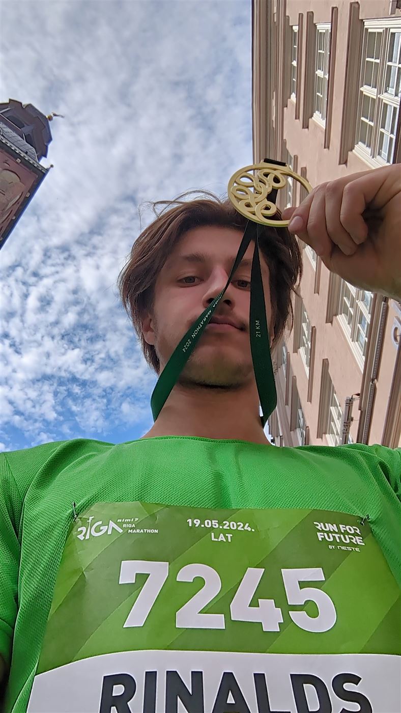 Rinalds with his Riga Marathon half-marathon finisher medal