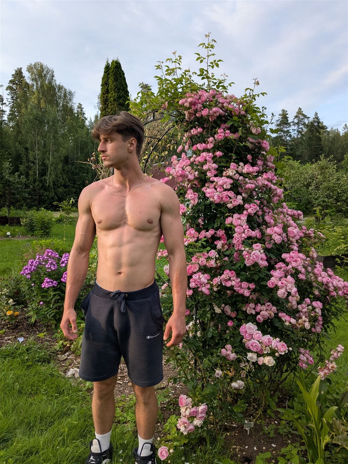 Rinalds Dērics, physique after four years of training, garden backdrop